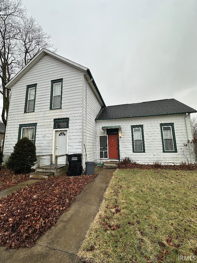 view of front of home featuring central AC and a front yard