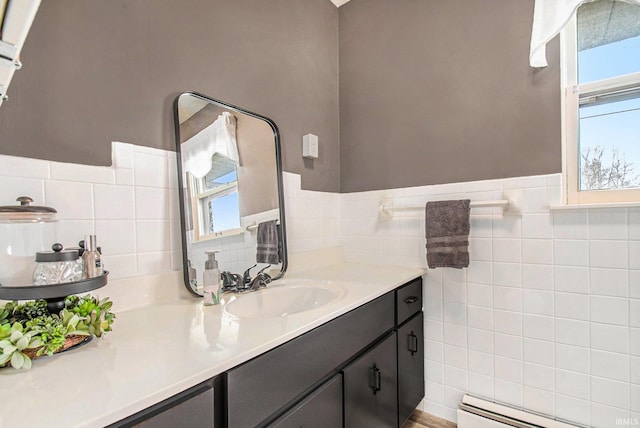 bathroom featuring vanity, a baseboard heating unit, and tile walls