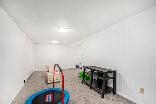 recreation room featuring a baseboard radiator and carpet