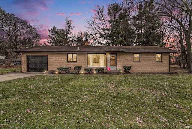 view of front of property featuring a garage and a yard