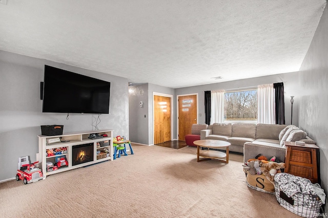 carpeted living room with a textured ceiling