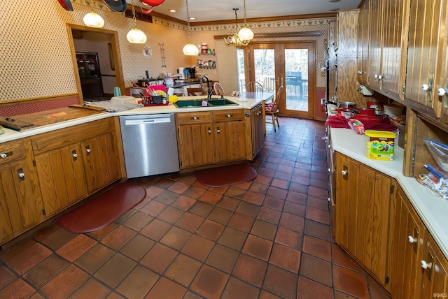 kitchen featuring sink, dark tile patterned floors, hanging light fixtures, stainless steel dishwasher, and kitchen peninsula