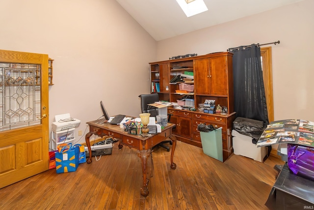 office featuring hardwood / wood-style floors and lofted ceiling with skylight