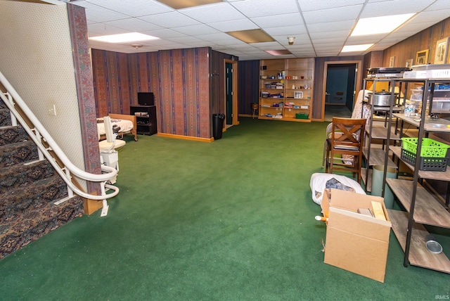 interior space featuring dark carpet and a drop ceiling