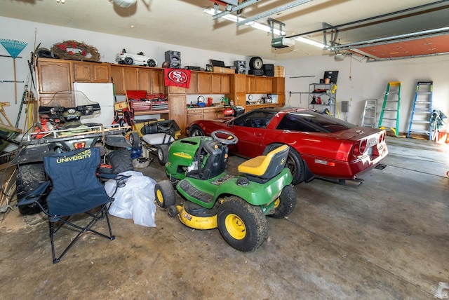 garage with a garage door opener and white refrigerator