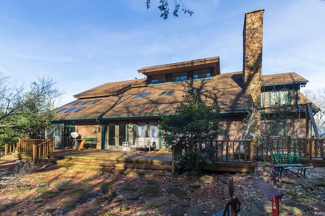 rear view of property featuring french doors and a deck