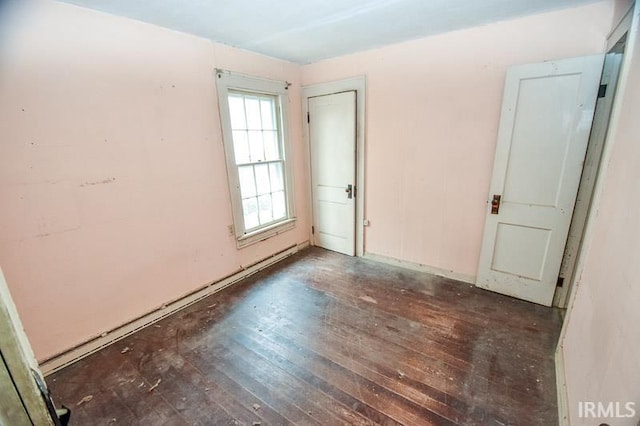 spare room featuring dark wood-type flooring