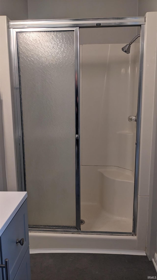 bathroom featuring vanity and an enclosed shower