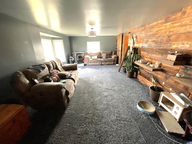 carpeted living room with wooden walls