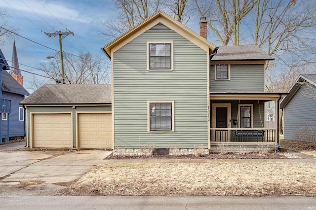 view of property with a garage and covered porch