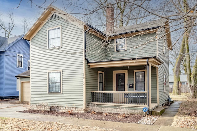 view of front property with a porch and a garage