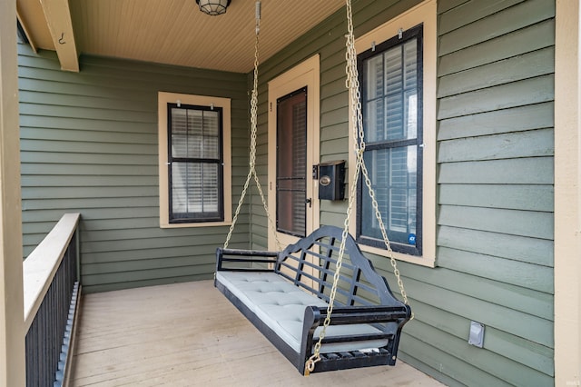 wooden terrace featuring covered porch