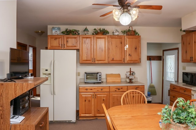 kitchen featuring white refrigerator with ice dispenser and ceiling fan