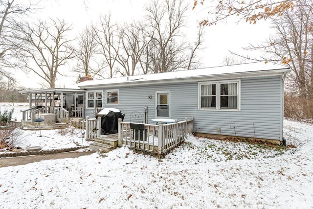 snow covered property featuring a deck