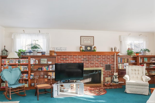 carpeted living room featuring a fireplace, ornamental molding, and a healthy amount of sunlight