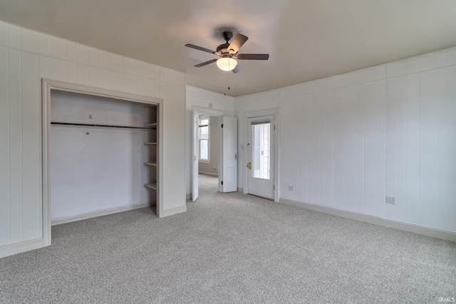 unfurnished bedroom featuring light colored carpet, a closet, and ceiling fan