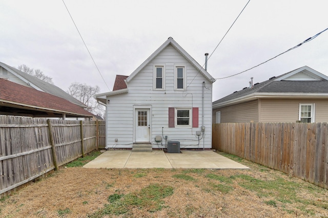 back of house featuring a patio area and a lawn