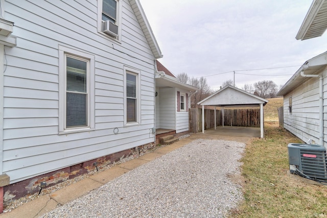 view of property exterior featuring a carport, cooling unit, and central AC unit