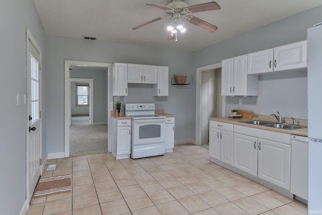 kitchen featuring ceiling fan, sink, white cabinets, and white appliances