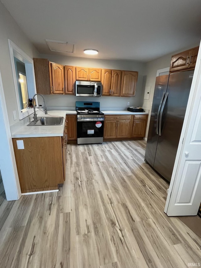 kitchen featuring sink, stainless steel appliances, and light wood-type flooring