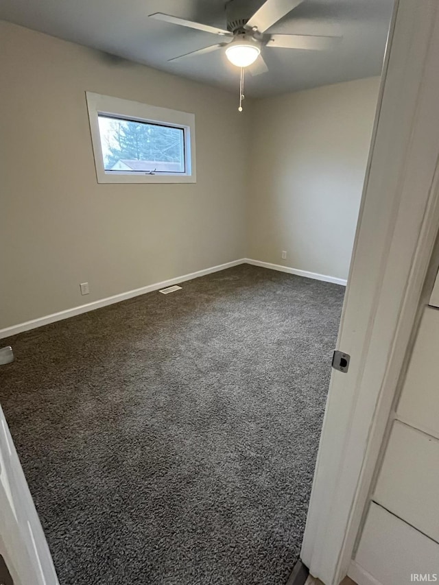 unfurnished room featuring ceiling fan and carpet floors