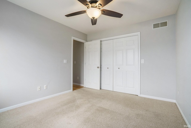 unfurnished bedroom featuring ceiling fan, carpet flooring, and a closet