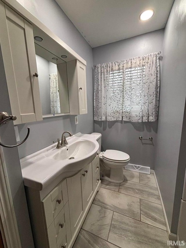 bathroom featuring vanity and toilet