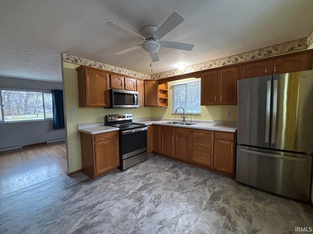 kitchen featuring sink, a baseboard radiator, stainless steel appliances, and ceiling fan