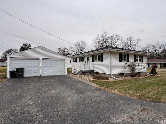 view of front of property with a garage, an outbuilding, and a front yard