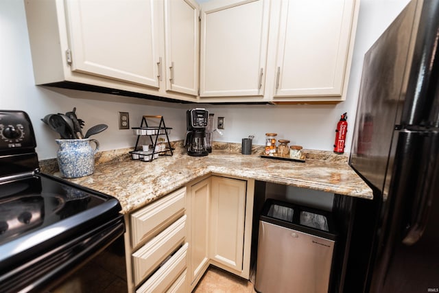 kitchen with light stone counters and black appliances