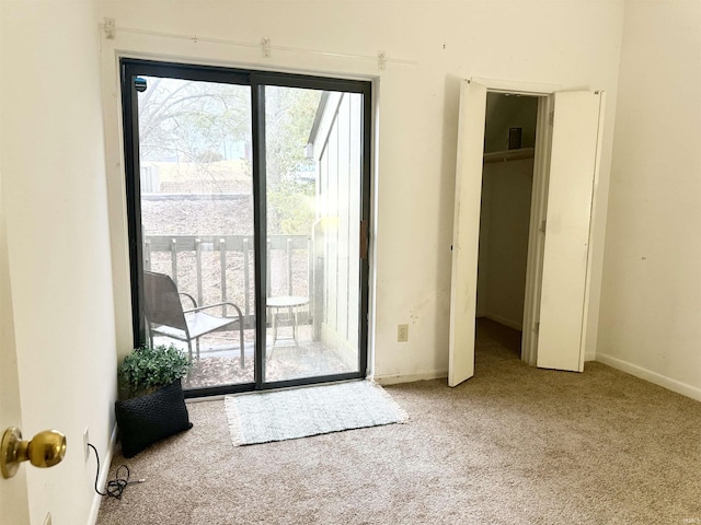 doorway to outside featuring carpet floors