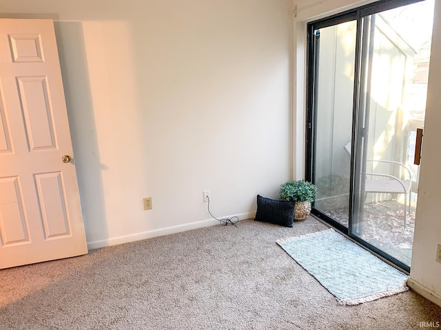 carpeted spare room featuring a wealth of natural light