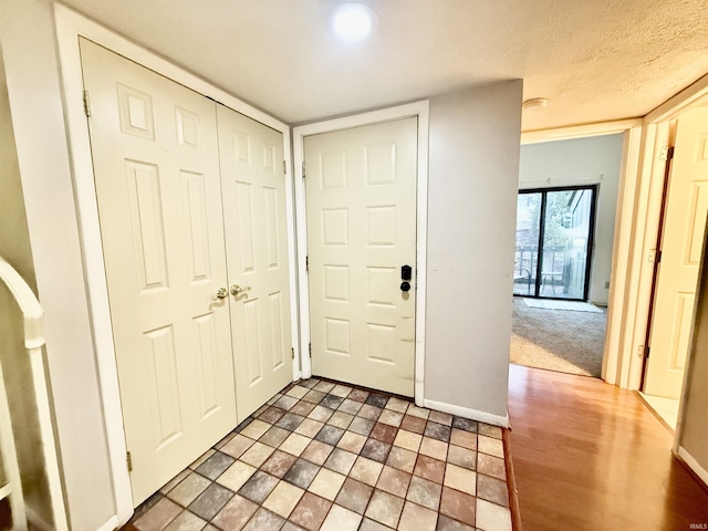 entryway with a textured ceiling