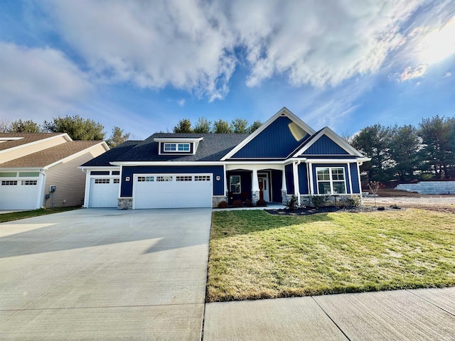 craftsman-style home featuring a garage and a front yard