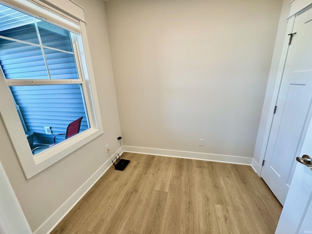 empty room with light hardwood / wood-style flooring