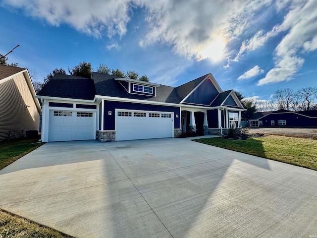 craftsman inspired home featuring a garage and a front yard