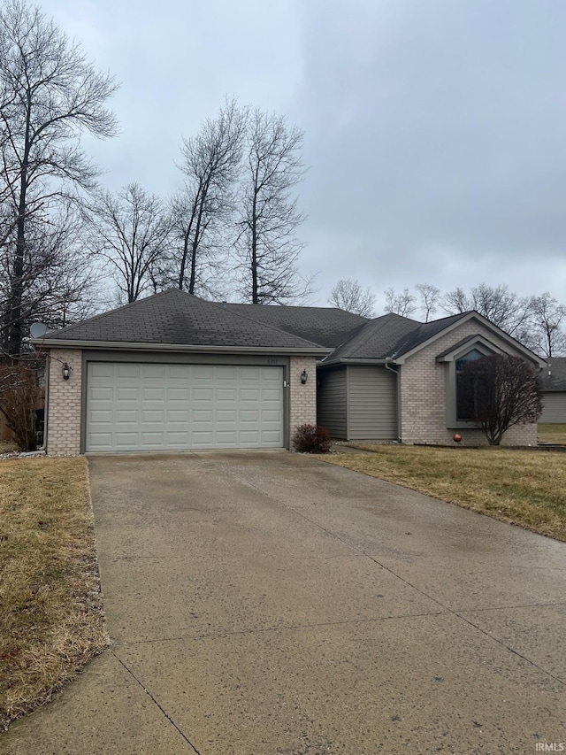 ranch-style home with a garage and a front yard