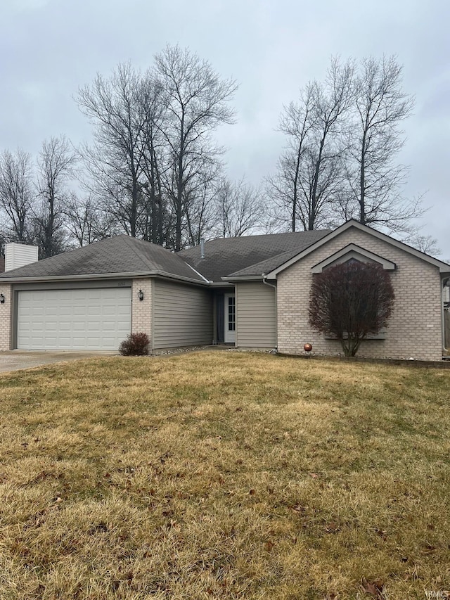 view of front of house with a garage and a front lawn