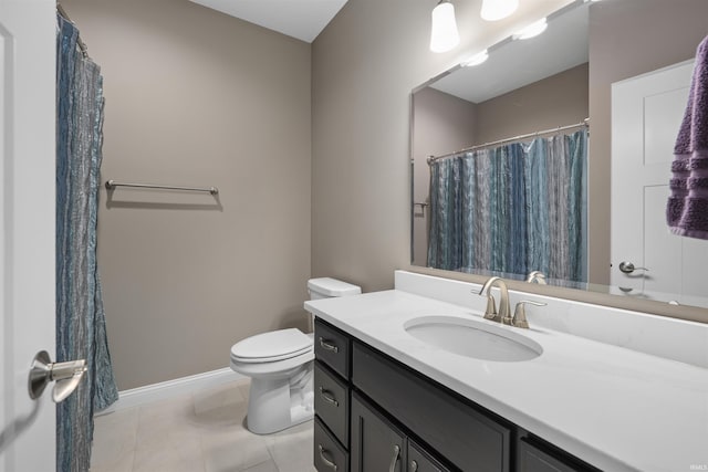 bathroom featuring tile patterned floors, vanity, and toilet