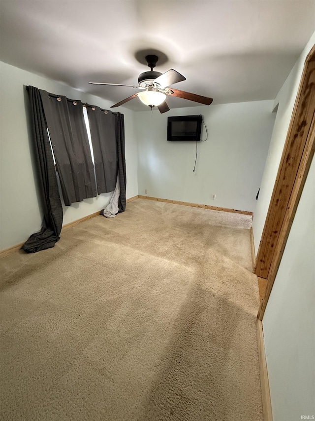 empty room with carpet floors, an AC wall unit, and ceiling fan