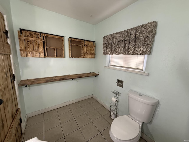 bathroom featuring toilet and tile patterned flooring