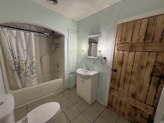 full bathroom with shower / bath combination with curtain, sink, toilet, and tile patterned flooring