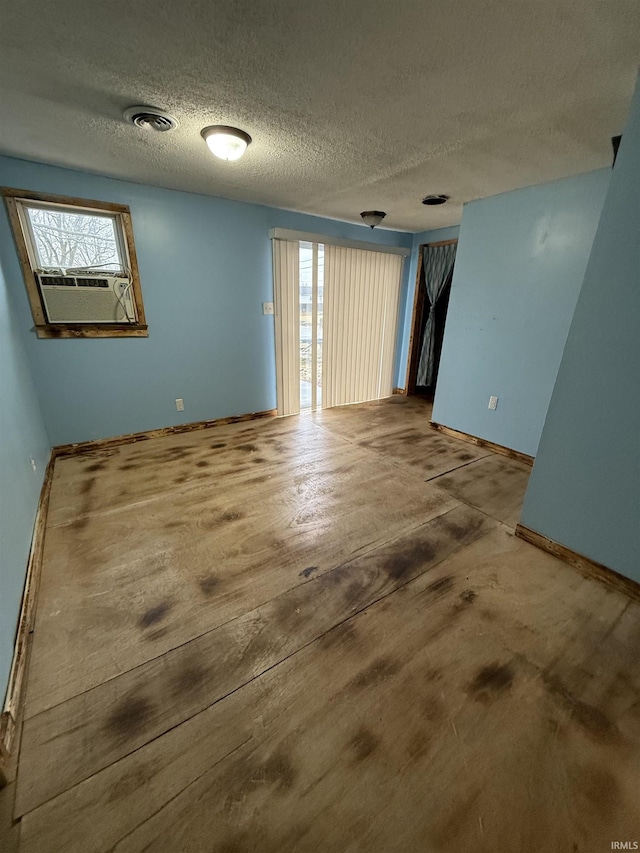 spare room featuring cooling unit and a textured ceiling