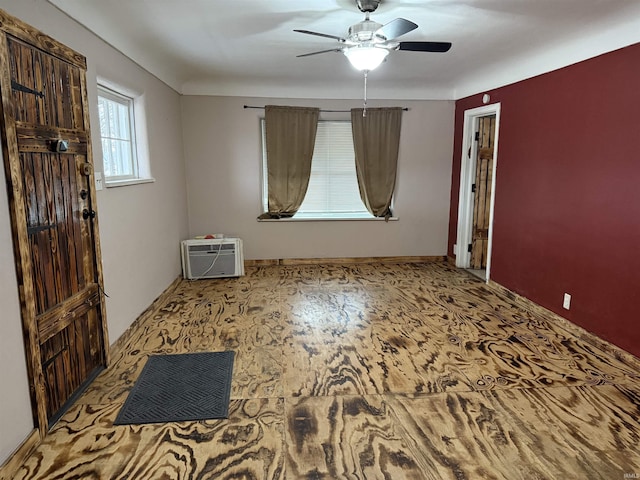 foyer entrance with an AC wall unit and ceiling fan