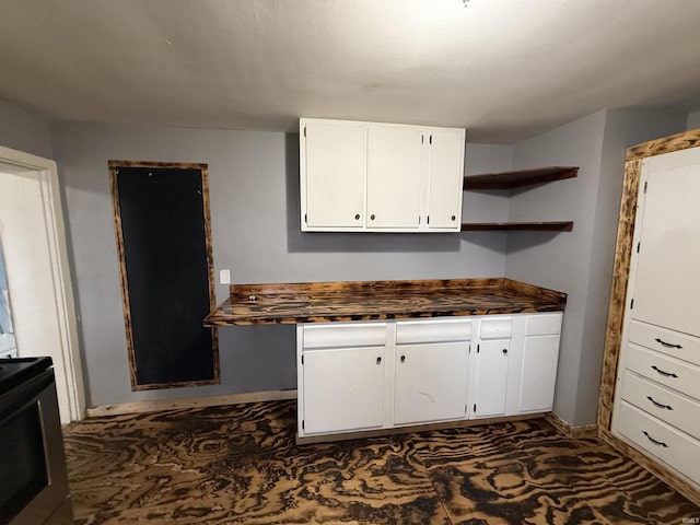 kitchen with white cabinetry and stove