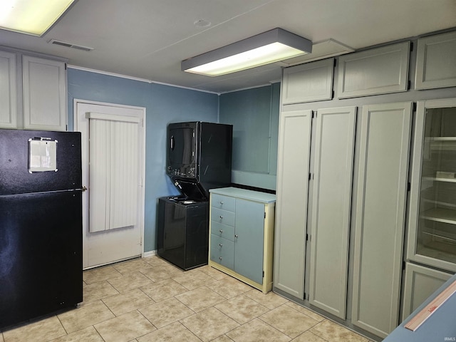 kitchen with gray cabinets, light tile patterned flooring, and black refrigerator