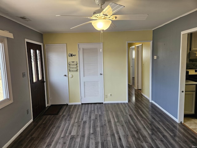 entrance foyer with ornamental molding, dark wood-type flooring, and ceiling fan