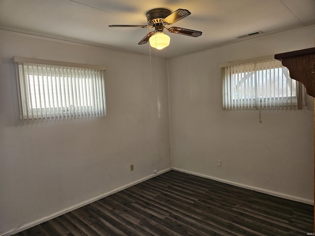 empty room featuring dark wood-type flooring and ceiling fan