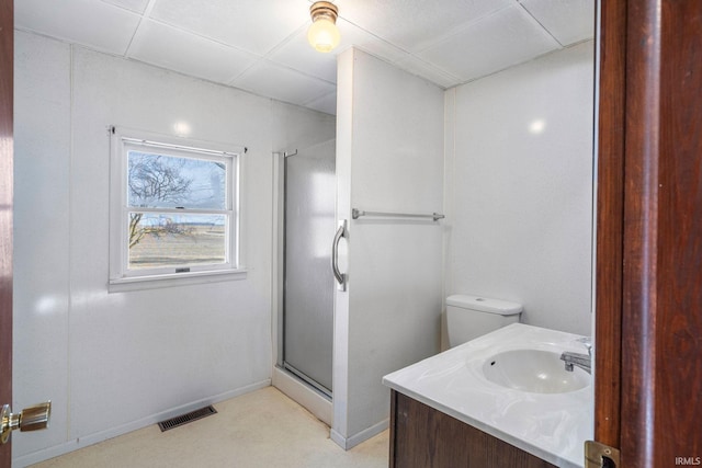 bathroom with vanity, a shower with shower door, and toilet