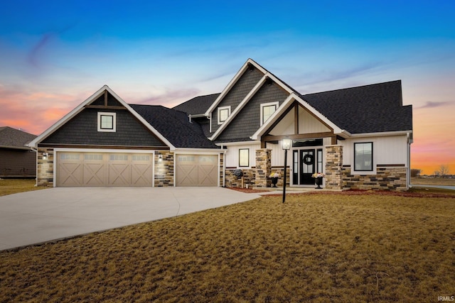 craftsman inspired home with a garage and a yard